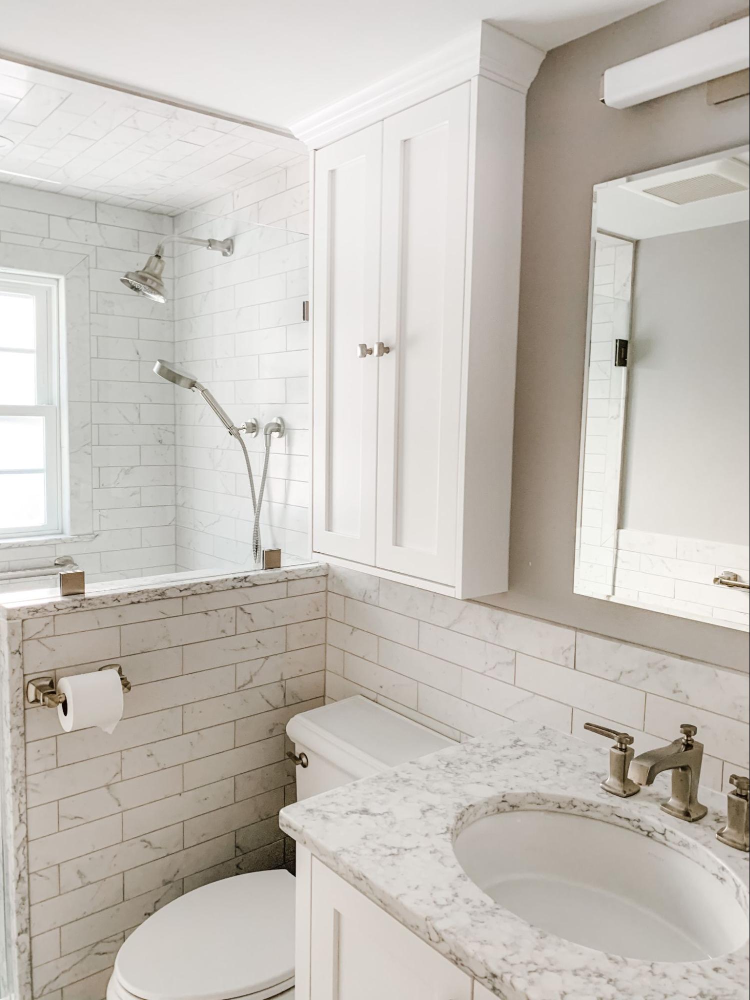 Bathroom addition with tiled shower, custom cabinetry and marble vanity